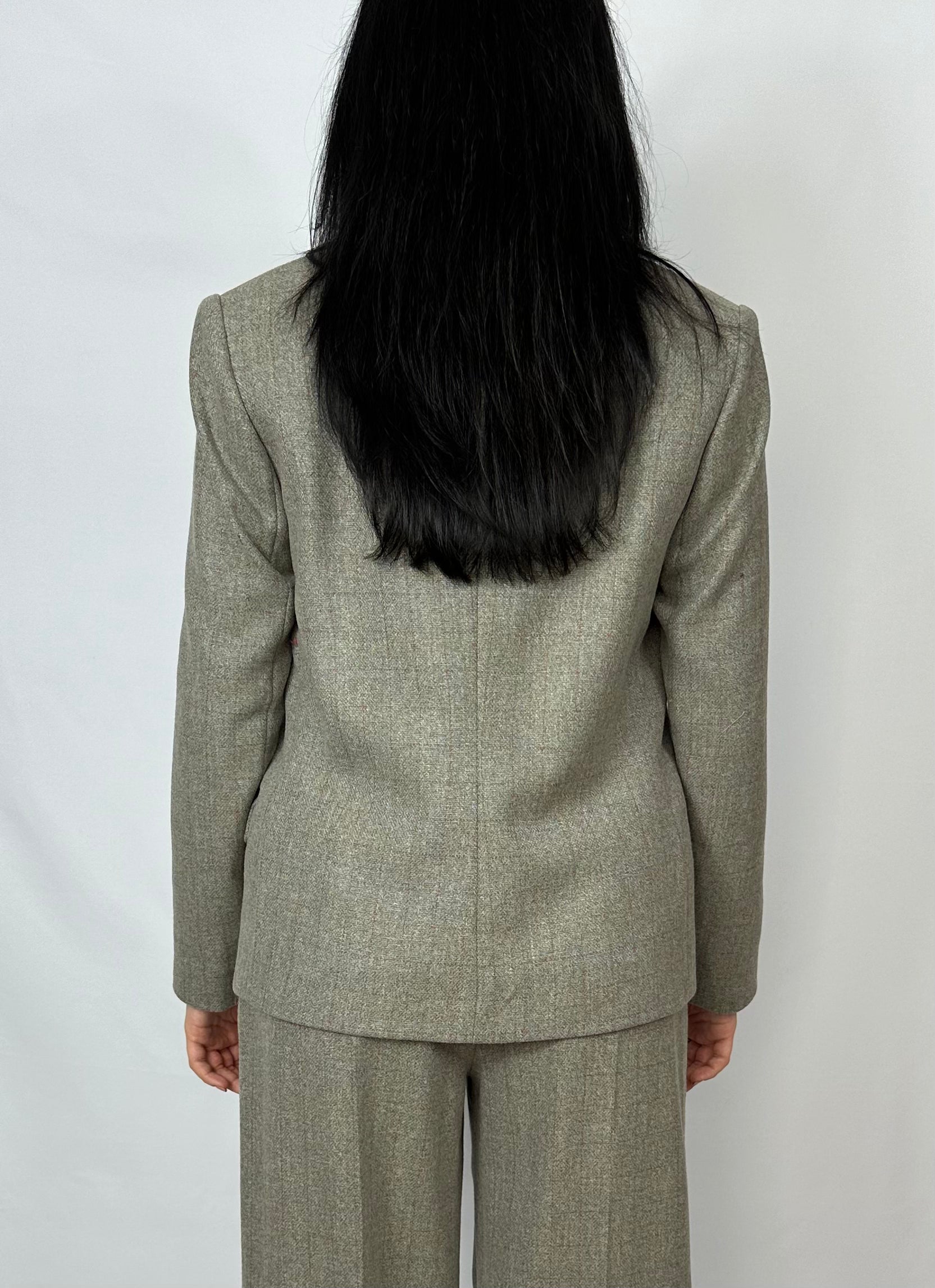 Back view of a model wearing a Sartorial Flair grey double-breasted blazer with matching trousers. The image highlights the tailored fit and elegant design of the suit, suitable for both formal and smart casual wear.