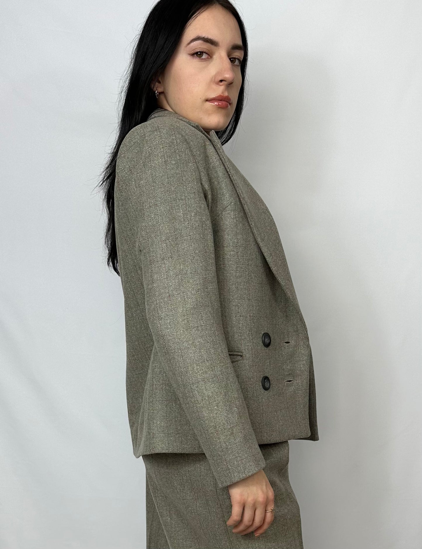 Model wearing a Sartorial Flair grey double-breasted blazer with matching grey trousers, showcasing a professional and versatile look. Ideal for formal occasions and smart casual styling. Perfect fit, elegant design, and high-quality fabric.