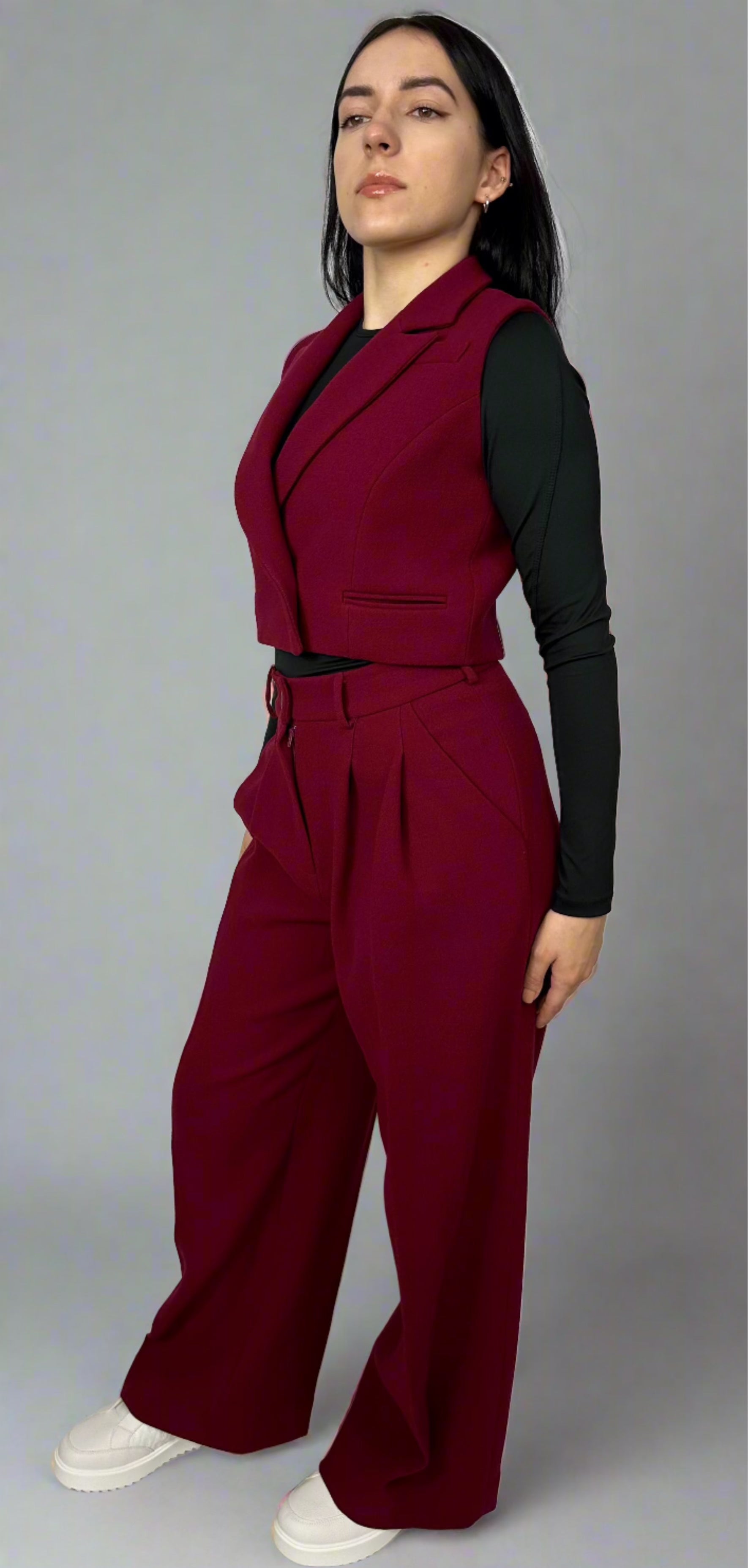 Model showcasing Sartorial Flair burgundy waistcoat and wide-leg trousers, highlighting the sleek design and sophisticated fit of the ensemble.