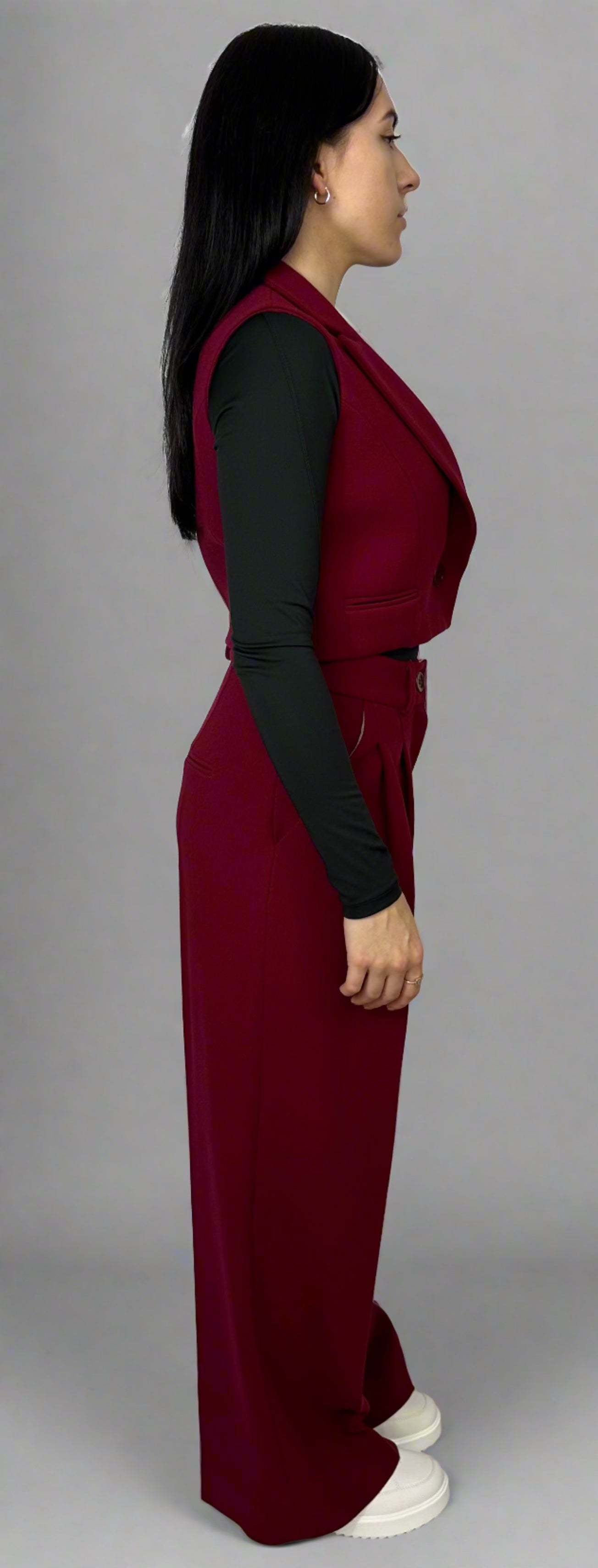 Model showcasing Sartorial Flair burgundy waistcoat and wide-leg trousers, highlighting the sophisticated tailoring and bold color of the ensemble.