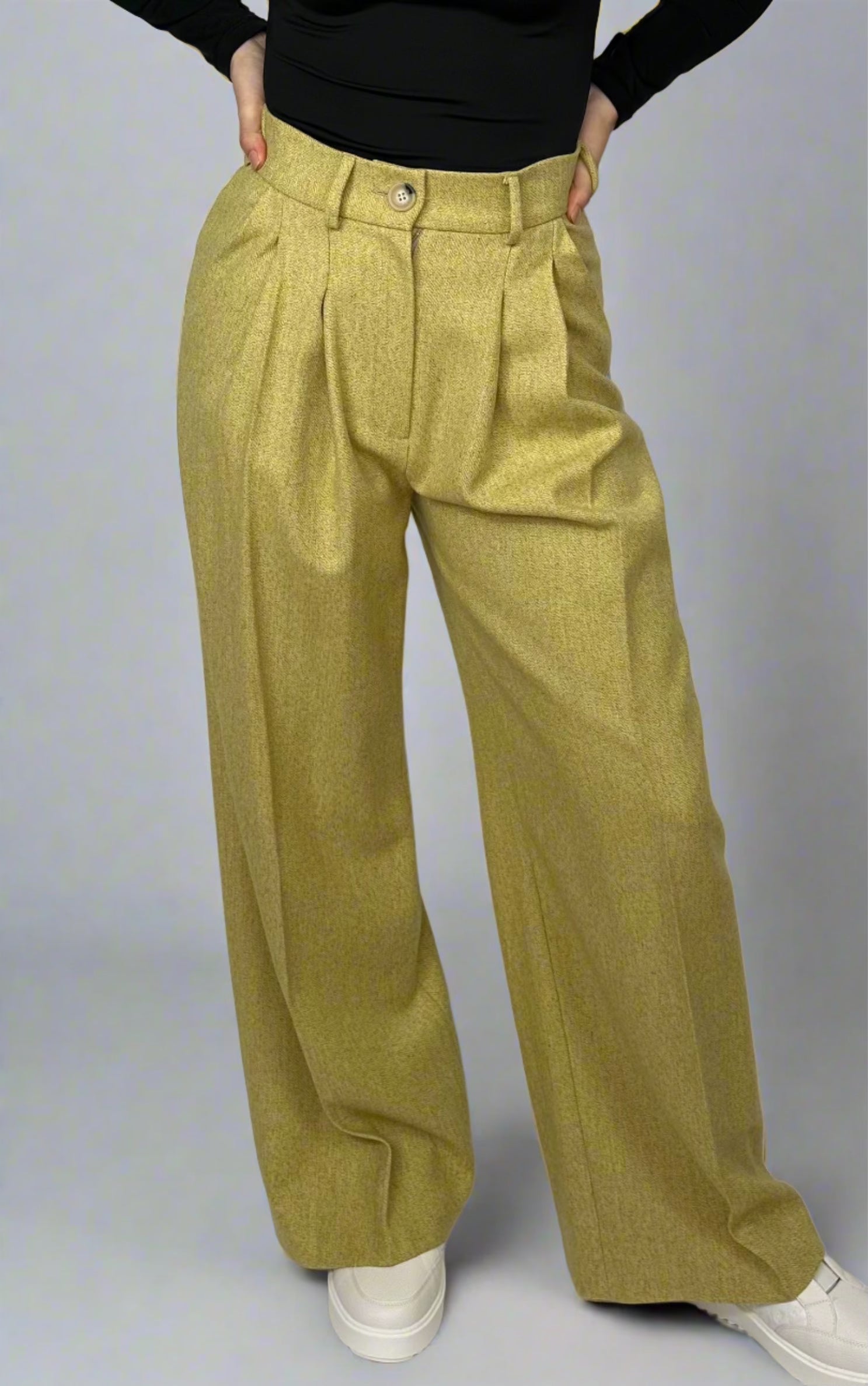 Close-up view of chartreuse wide-leg trousers from Sartorial Flair, detailed with front pleats and a fitted waistband, exemplifying chic tailoring and modern style.