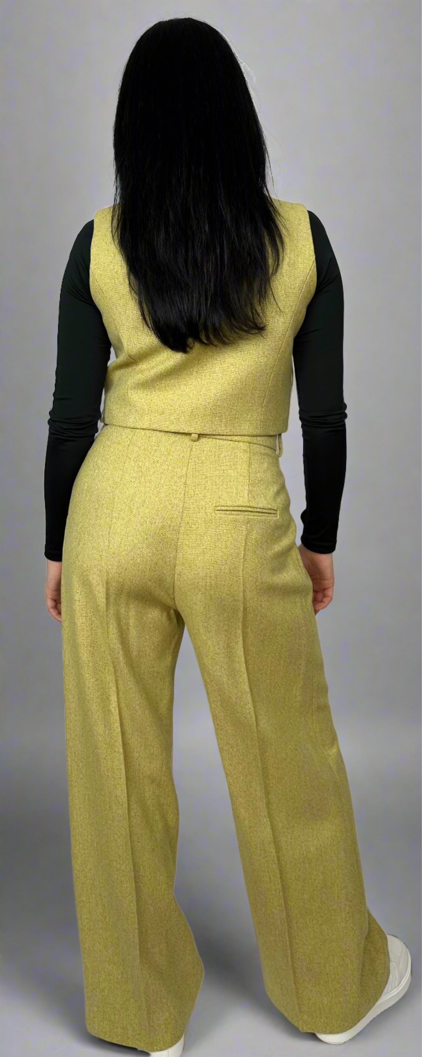 Rear view of a vibrant chartreuse wool waistcoat and wide-leg trousers ensemble from Sartorial Flair, featuring a sleek silhouette and high-waisted design, ideal for contemporary professional attire.