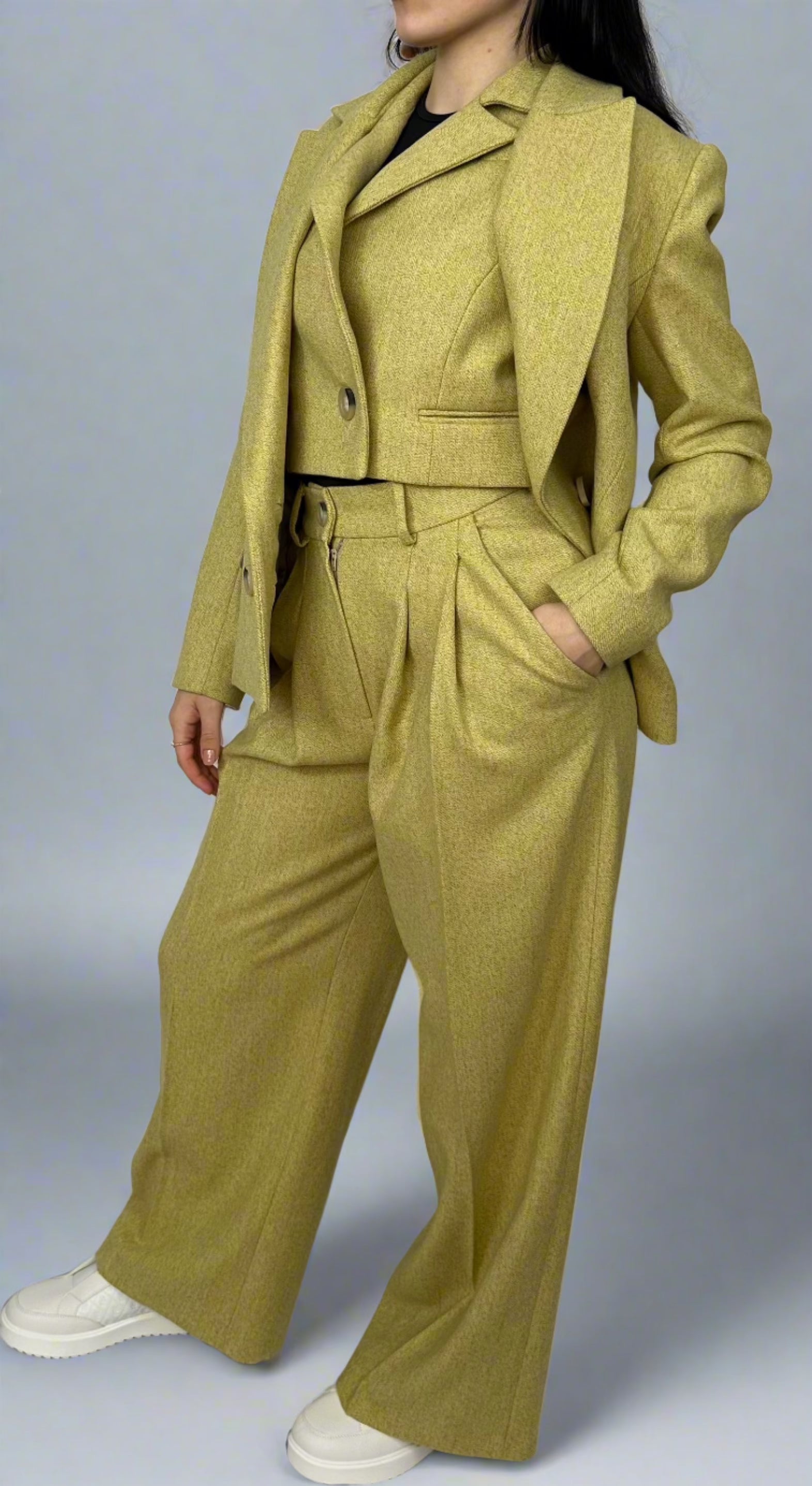 Stylish woman posing in a belted chartreuse Sartorial Flair suit, featuring a textured double-breasted blazer and coordinating wide-leg trousers, perfect for making a fashion-forward statement.