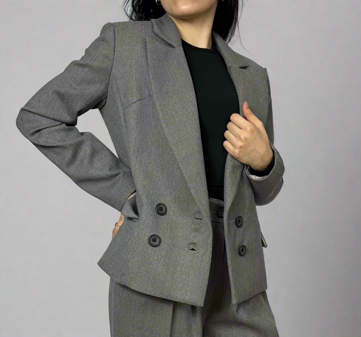 Elegant professional look showcased by a woman in a grey Zoe double-breasted blazer paired with matching trousers, perfect for business or casual chic style, available at Sartorial Flair.