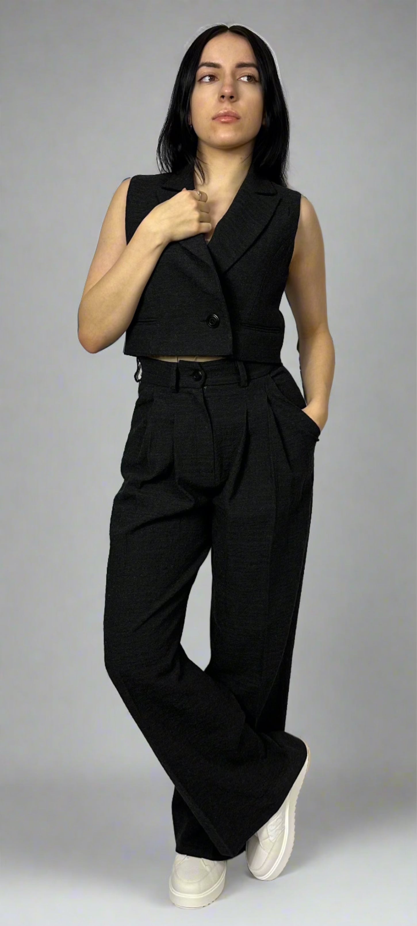 Model showcasing Sartorial Flair black waistcoat and wide-leg trousers, emphasizing the tailored fit and elegant style of the outfit.