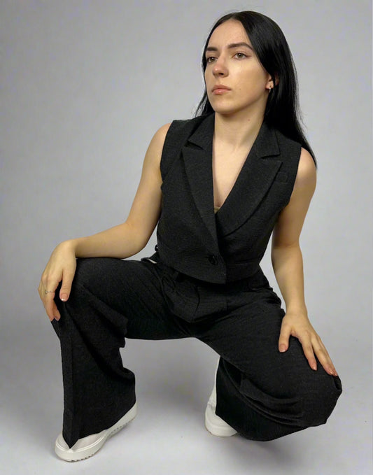 Model wearing Sartorial Flair black waistcoat and wide-leg trousers, highlighting the sleek and modern design of the tailored ensemble.